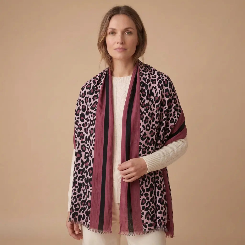 Berry Blush Leopard Print Scarf draped on a model in an ivory jumper