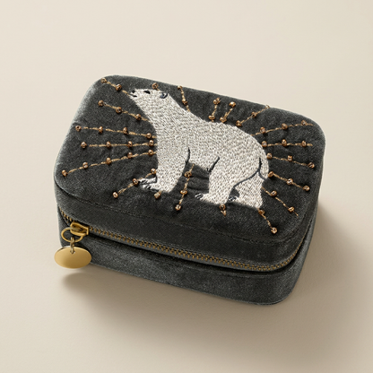 Arctic Glow charcoal-grey jewellery box with embroidered white polar bear and gold-tone beaded details on a warm-neutral background